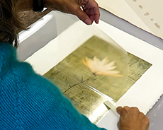 Lynn Nafey making a pigment transfer print of "Rising", one of her mixed media digital collages